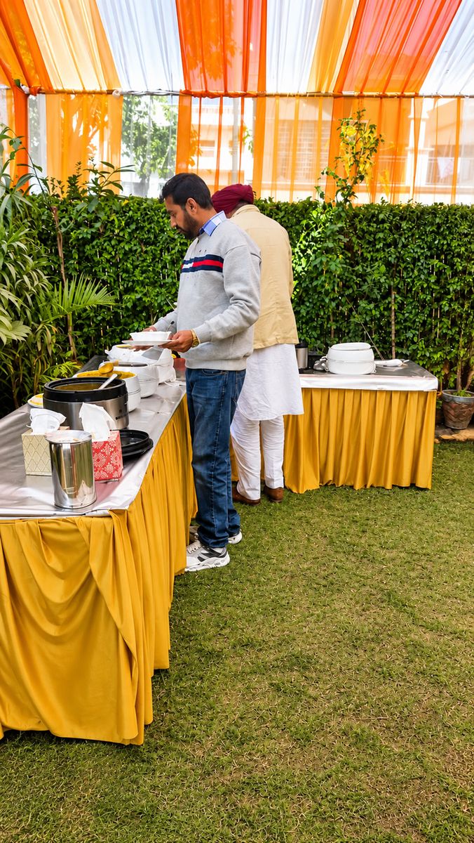Guests at a buffet our kitchen set up for an outdoor function