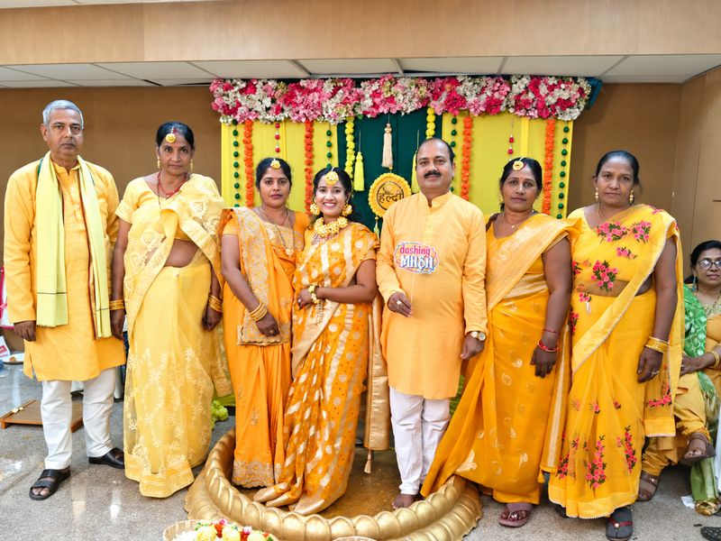 Family gathered in yellow for a haldi celebration