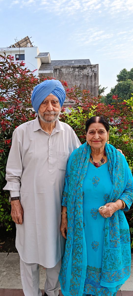 Bhupinder and Jagjit standing together in a garden